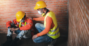 Construction workers comforting each other on site.